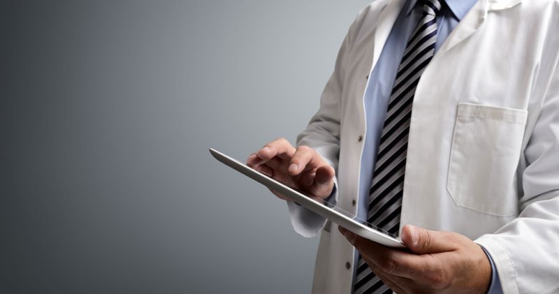 A professional tapping on a tablet