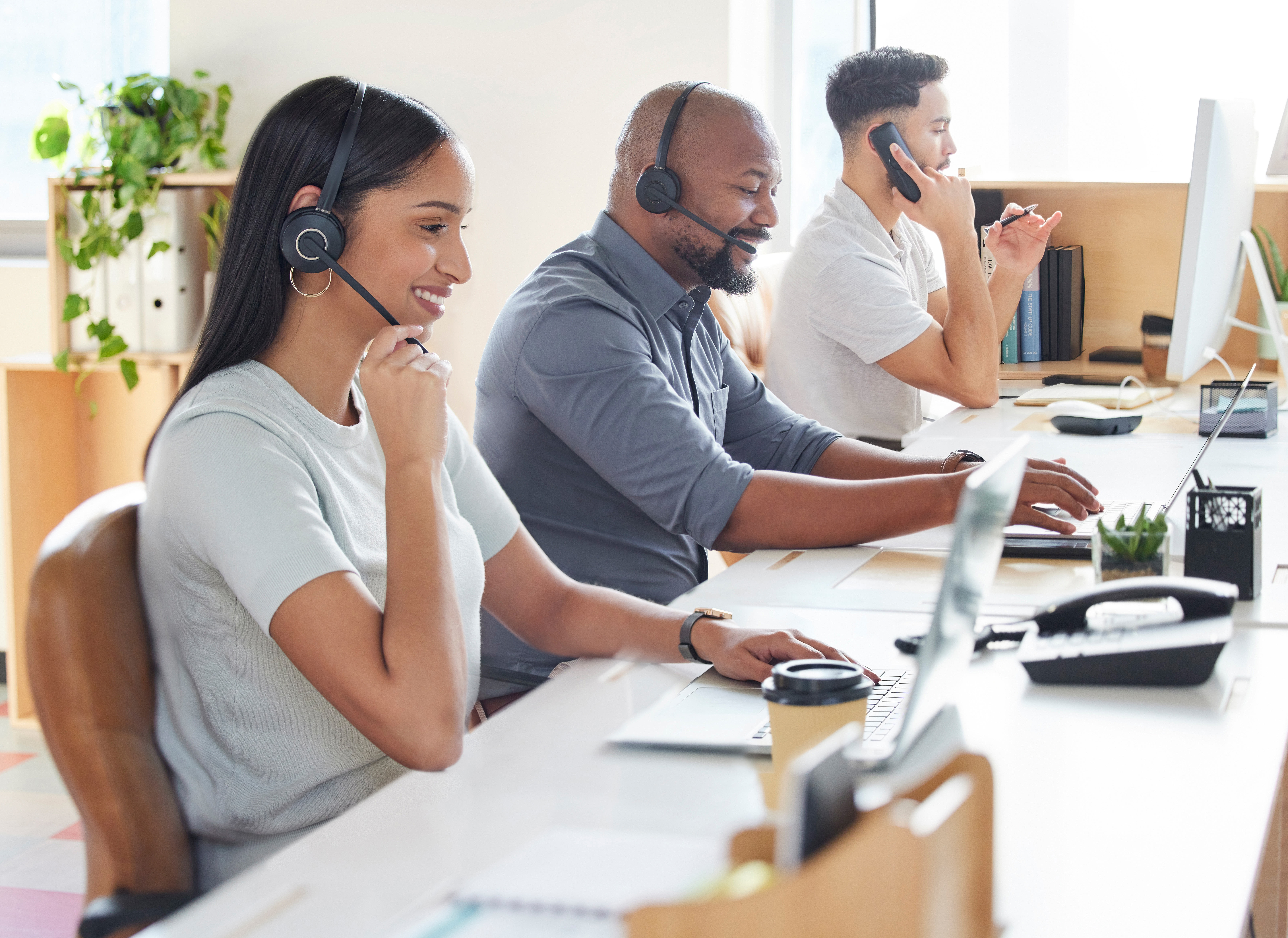 Professionals using headsets and laptops reveal drawbacks of outdated systems